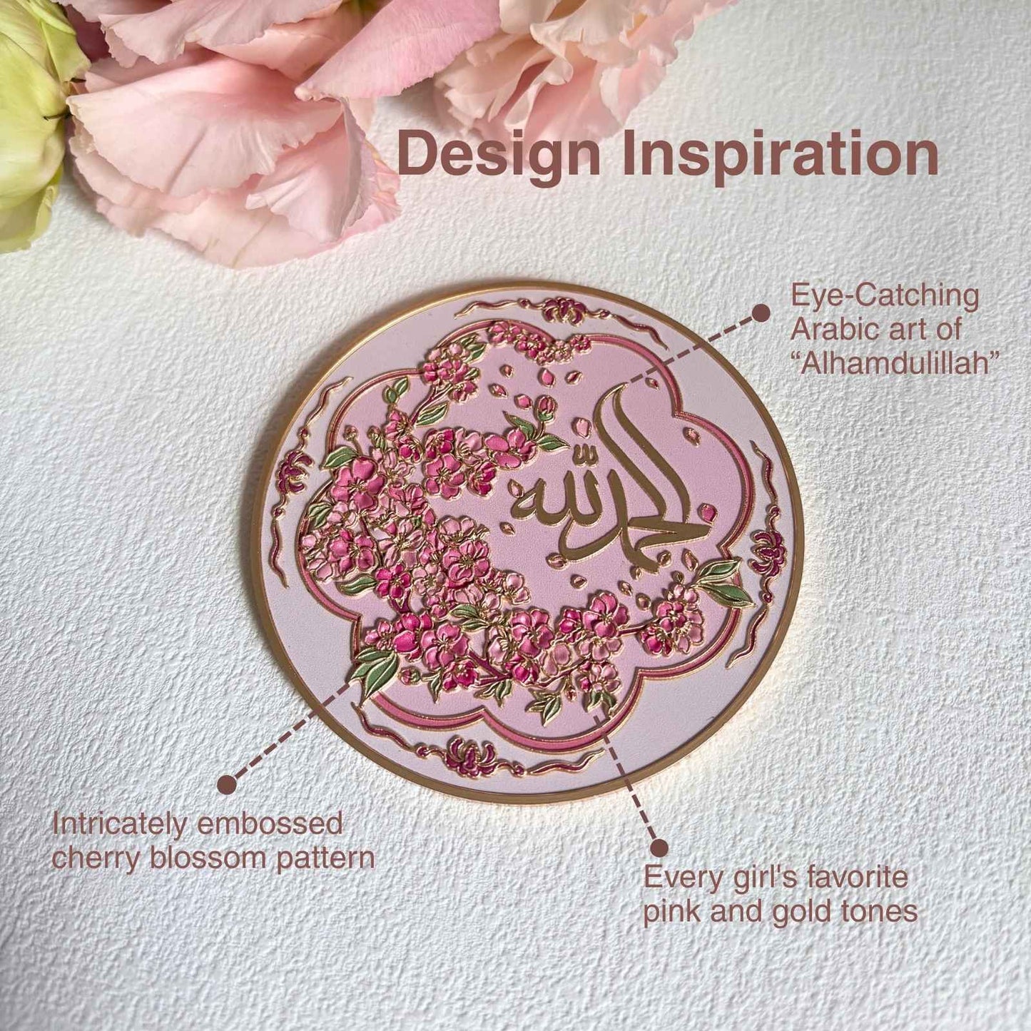 Close-up embossed Alhamdulillah Arabic calligraphy with raised floral detail on pink metal surface