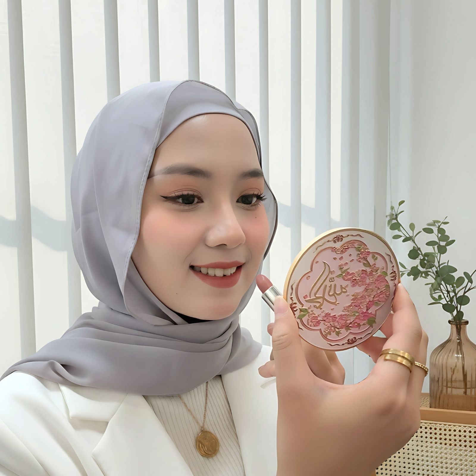 Muslim woman holding Alhamdulillah pocket mirror, portable compact for daily use and travel